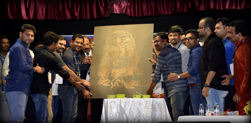 Community members unveiling artwork at an Edappalayam gathering